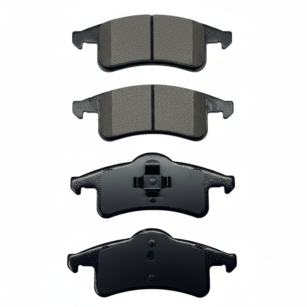 Four black brake pads on a white background