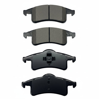 Four black brake pads on a white background
